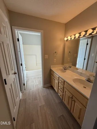 a bathroom with a double vanity sink and a mirror