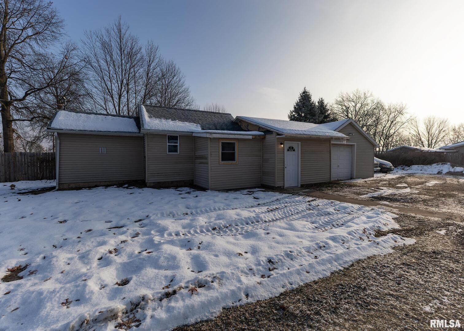 513 3rd Street Camanche, IA 52730 - Photo 2 of 13 a view of a house with a yard