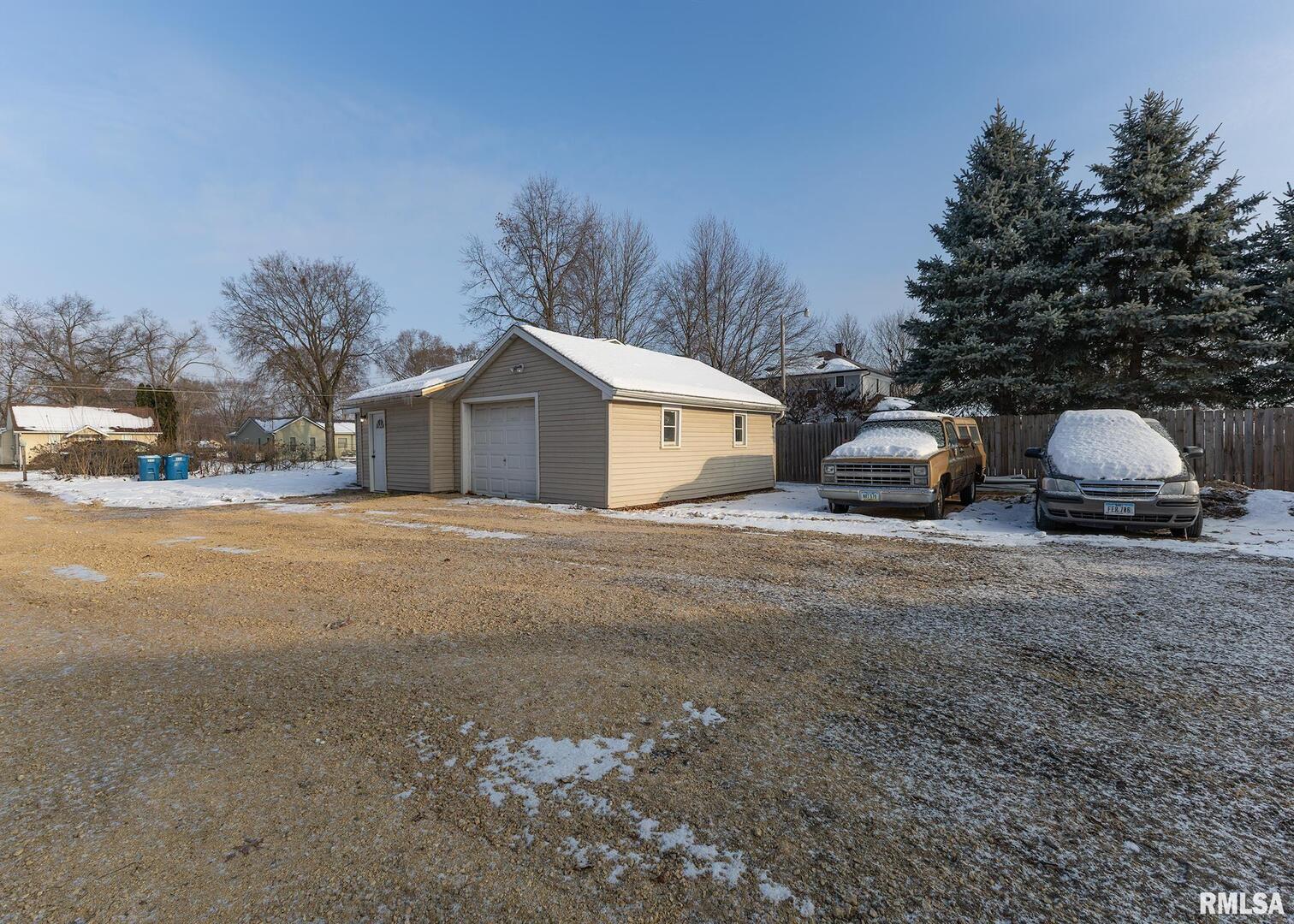 513 3rd Street Camanche, IA 52730 - Photo 3 of 13 a view of a house with backyard and trees