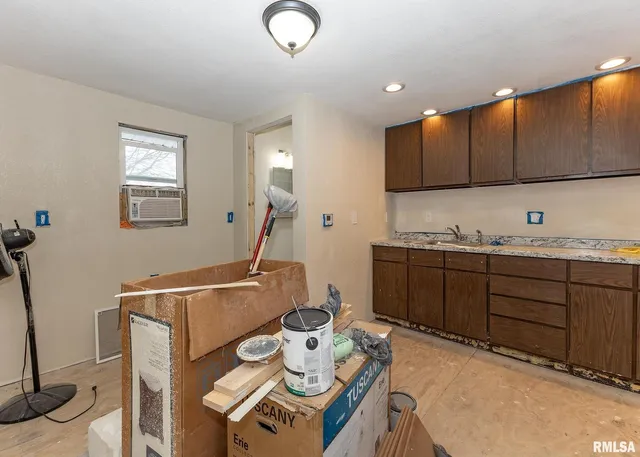 a kitchen with cabinets a sink and appliances