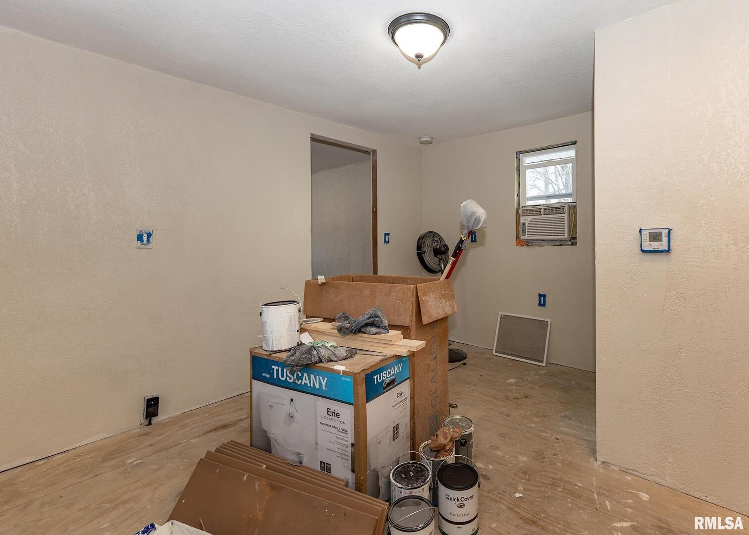 513 3rd Street Camanche, IA 52730 - Photo 8 of 13 a room with chair and white walls