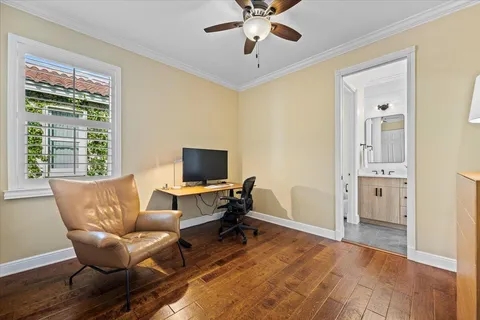 a spacious bedroom with a bed and a chandelier