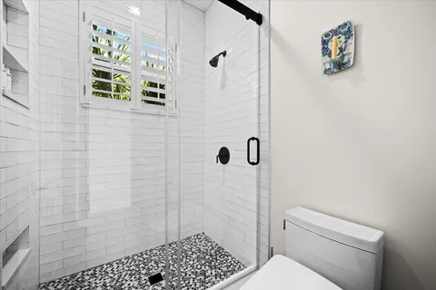 a spacious bathroom with a double vanity sink mirror and a bathtub