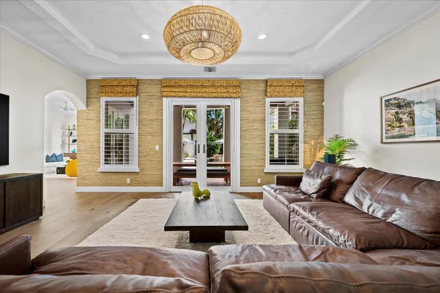 a kitchen with stainless steel appliances kitchen island granite countertop a table chairs and a refrigerator
