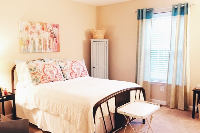 232 Sanders Road Macon, GA 31210 - Photo 26 of 33 a bedroom with a bed and a table with bookshelf