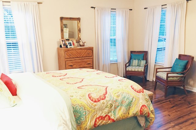 232 Sanders Road Macon, GA 31210 - Photo 30 of 33 a bedroom with a bed and wooden floor