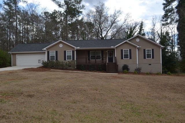232 Sanders Road Macon, GA 31210 - Photo 9 of 33 a front view of a house with a garden and yard