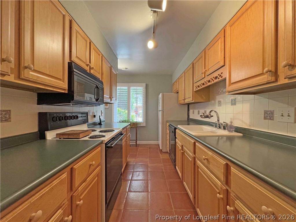 190 Palmetto Road Pinehurst, NC 28374 - Photo 8 of 19 a kitchen with stainless steel appliances granite countertop a sink and cabinets