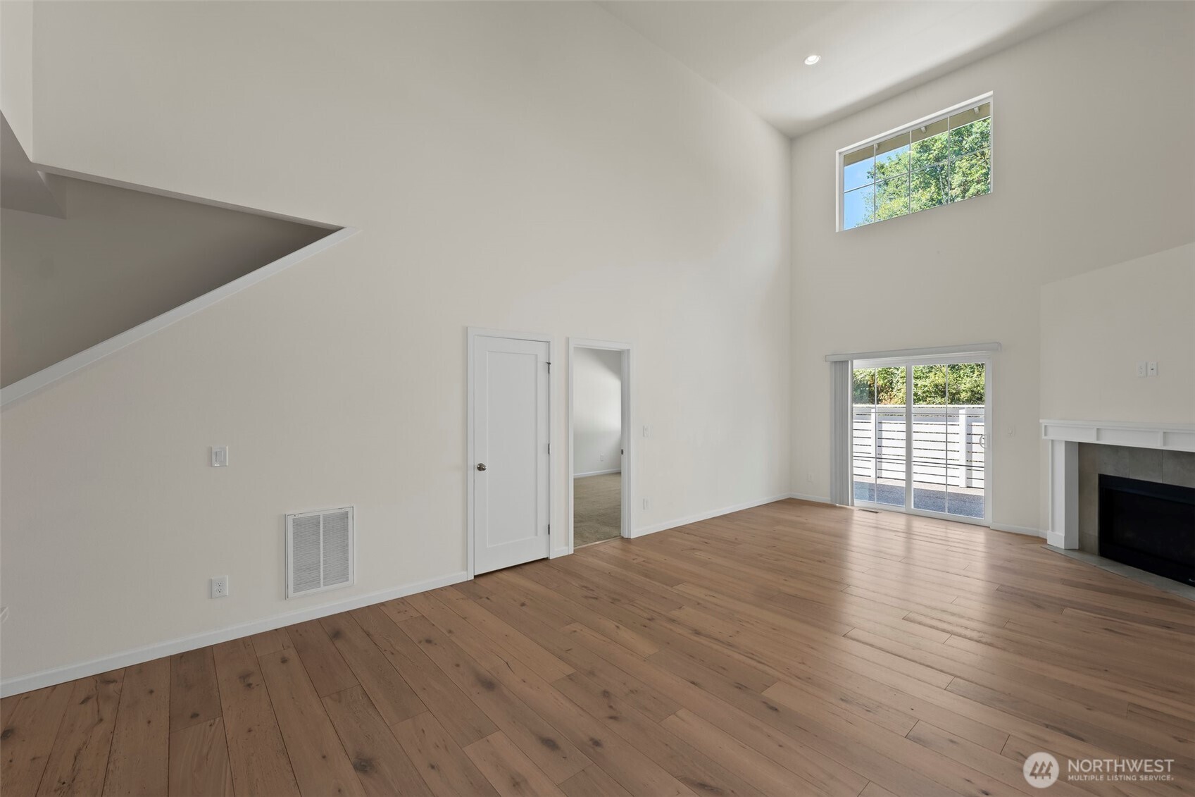 1080 East Old Ranch Road, Unit A1A2 Allyn, WA 98524 - Photo 15 of 35 a view of an empty room with wooden floor and a window