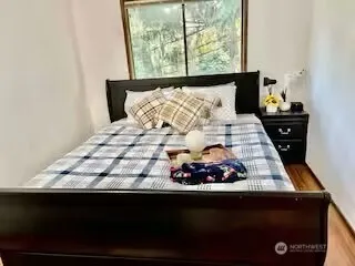 a bed sitting in a bedroom next to a window
