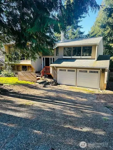 a view of a house with pool and chairs