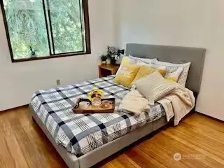 a bed sitting in a bedroom next to a window
