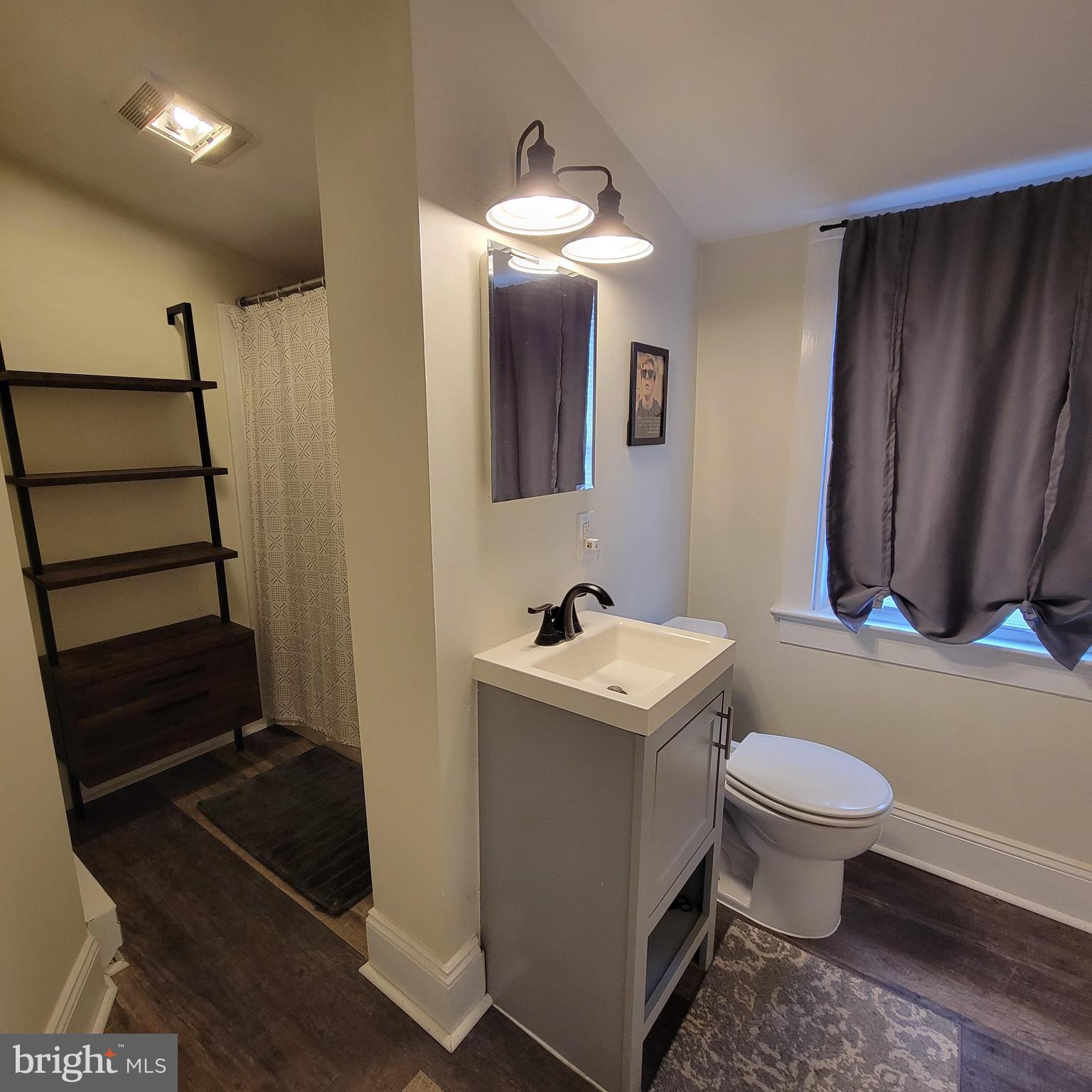 127 2nd Avenue Pitman, NJ 08071 - Photo 14 of 36 a bathroom with a toilet a sink and mirror