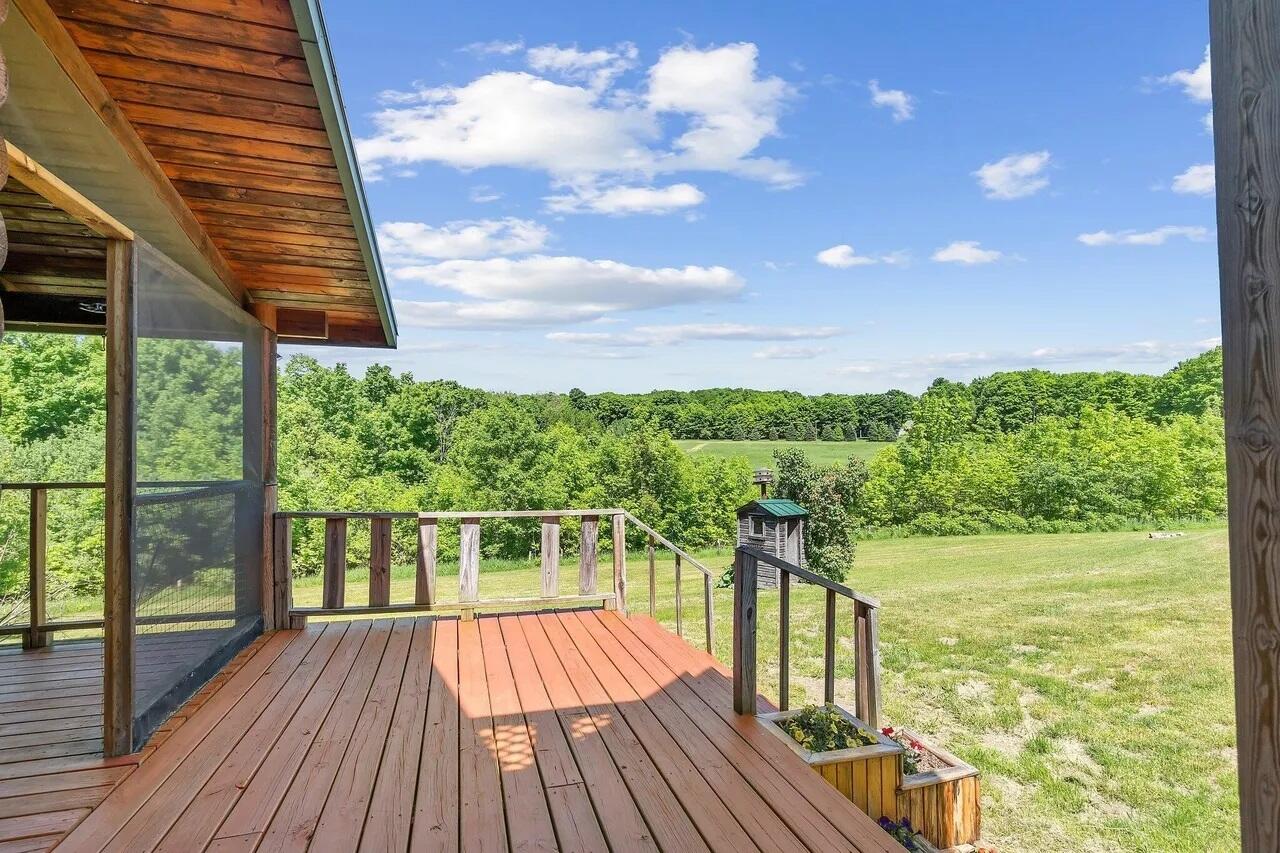 9735 Quarterline Road Charlevoix, MI 49720 - Photo 3 of 51 EAST SIDE PORCH