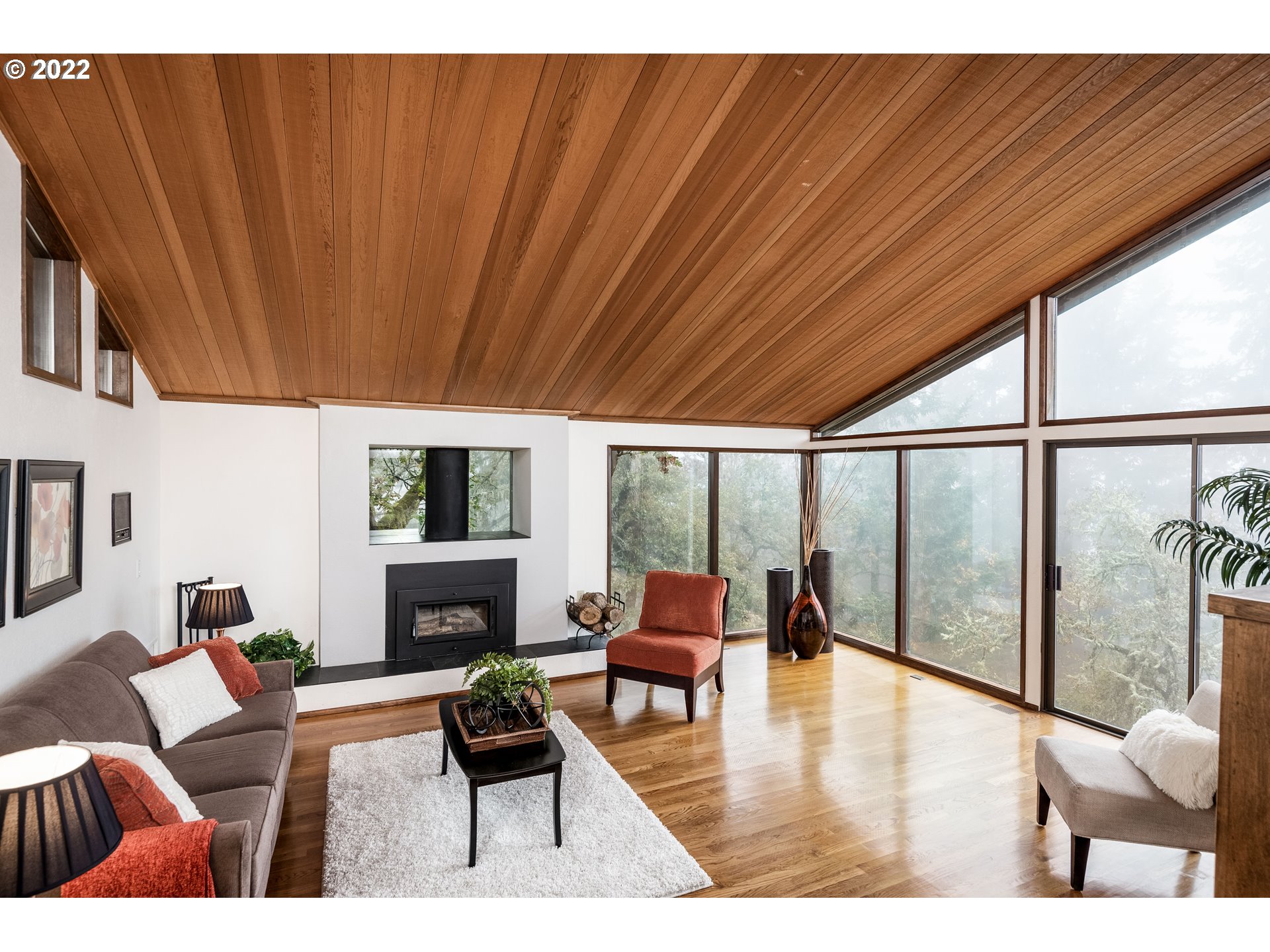 635 Startouch Drive Eugene, OR 97405 - Photo 2 of 28 a living room with furniture a fireplace and a floor to ceiling window