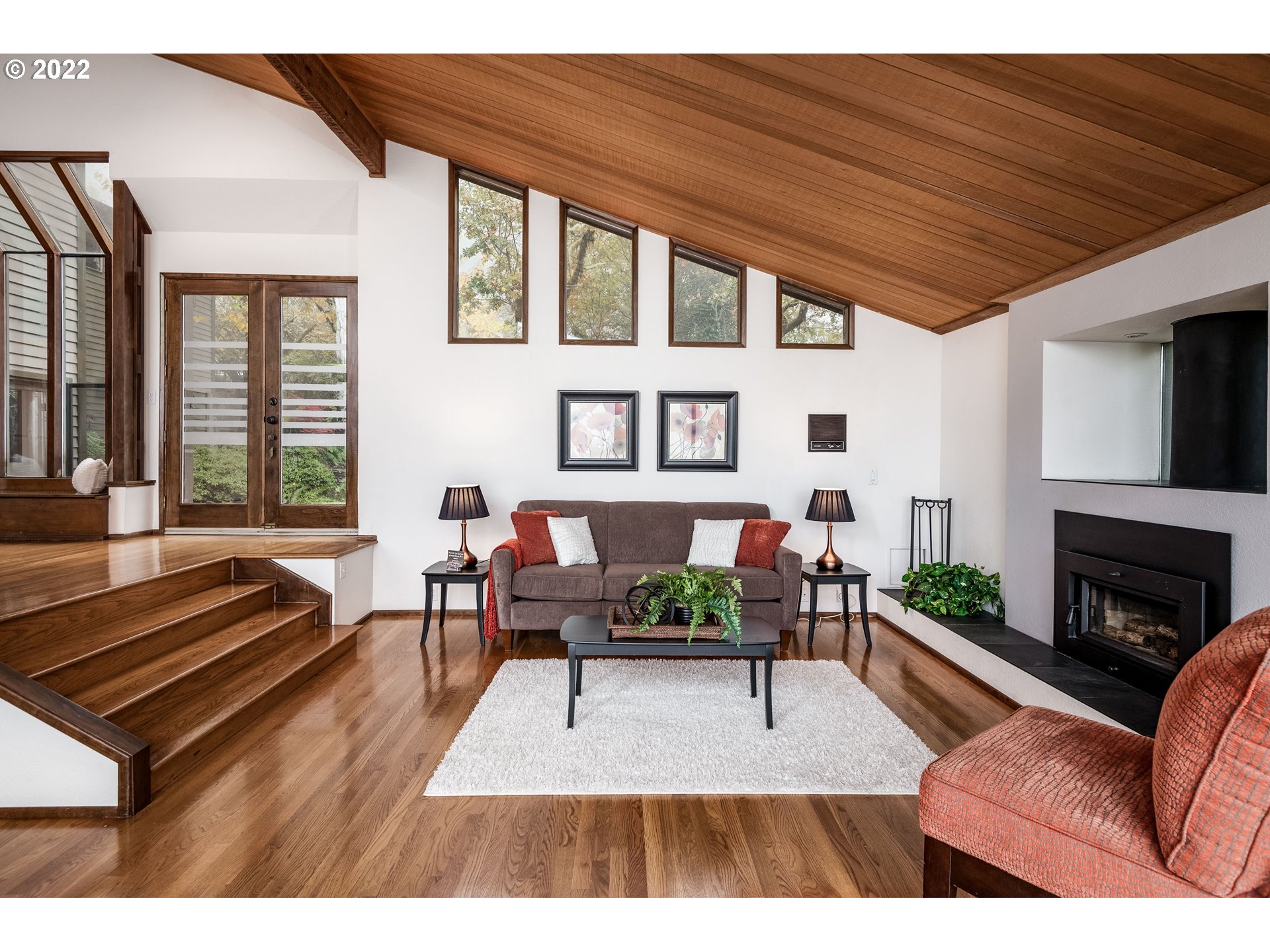 635 Startouch Drive Eugene, OR 97405 - Photo 4 of 28 a living room with furniture a fireplace wooden floor and a flat screen tv