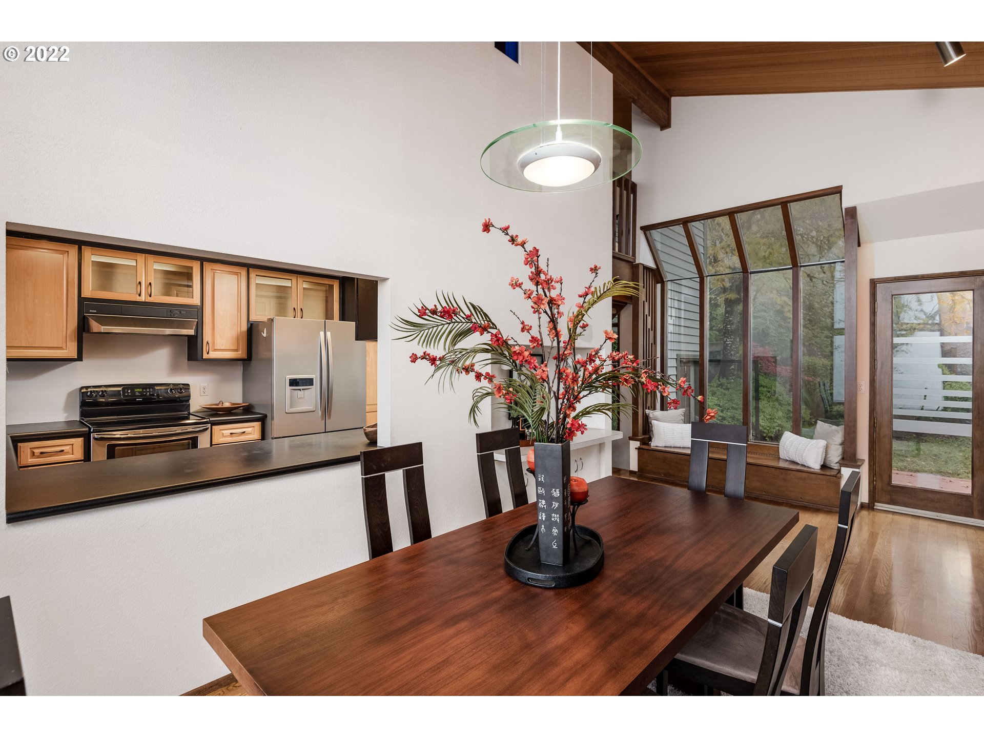 635 Startouch Drive Eugene, OR 97405 - Photo 8 of 28 a kitchen with stainless steel appliances kitchen island granite countertop a table chairs in it and wooden floor