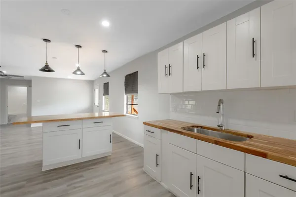 a kitchen with granite countertop white cabinets and white appliances