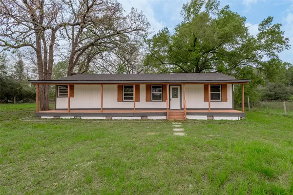 a backyard of a house with lots of green space