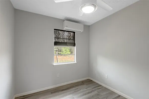 a view of an empty room and wooden floor