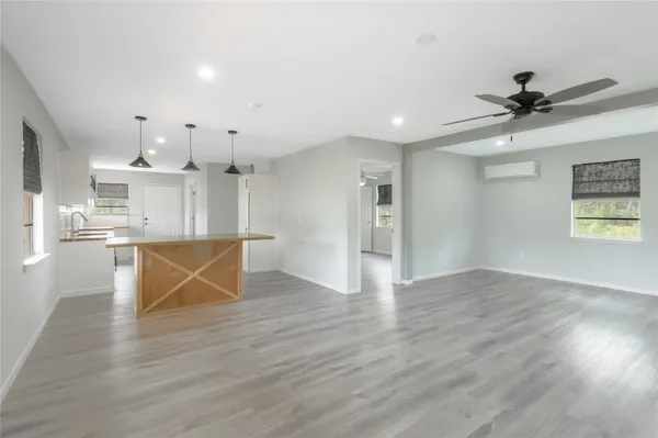 a view of a kitchen with wooden floor and a kitchen