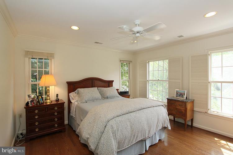 5119 Warren Place Northwest Washington, DC 20016 - Photo 17 of 30 a bedroom with a bed and wooden floor