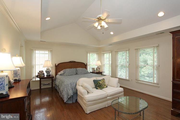 5119 Warren Place Northwest Washington, DC 20016 - Photo 21 of 30 a spacious bedroom with a large bed and a chandelier