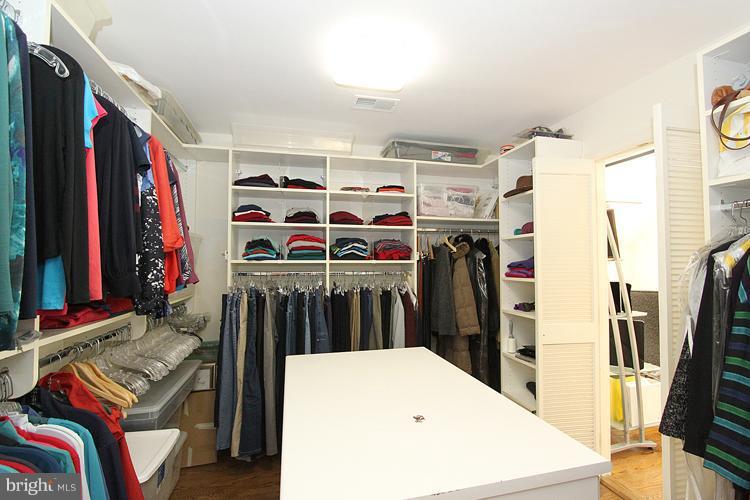 5119 Warren Place Northwest Washington, DC 20016 - Photo 22 of 30 a view of walk in closet with clothes and shoes