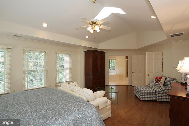 5119 Warren Place Northwest Washington, DC 20016 - Photo 24 of 30 a bedroom with a bed and a chandelier