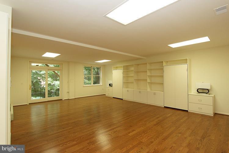 5119 Warren Place Northwest Washington, DC 20016 - Photo 25 of 30 a view of an empty room with wooden floor and a window