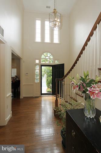 5119 Warren Place Northwest Washington, DC 20016 - Photo 4 of 30 a view of entryway and kitchen with a chandelier