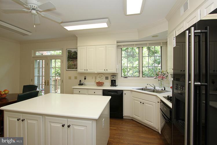 5119 Warren Place Northwest Washington, DC 20016 - Photo 6 of 30 a kitchen with a sink a window and stainless steel appliances