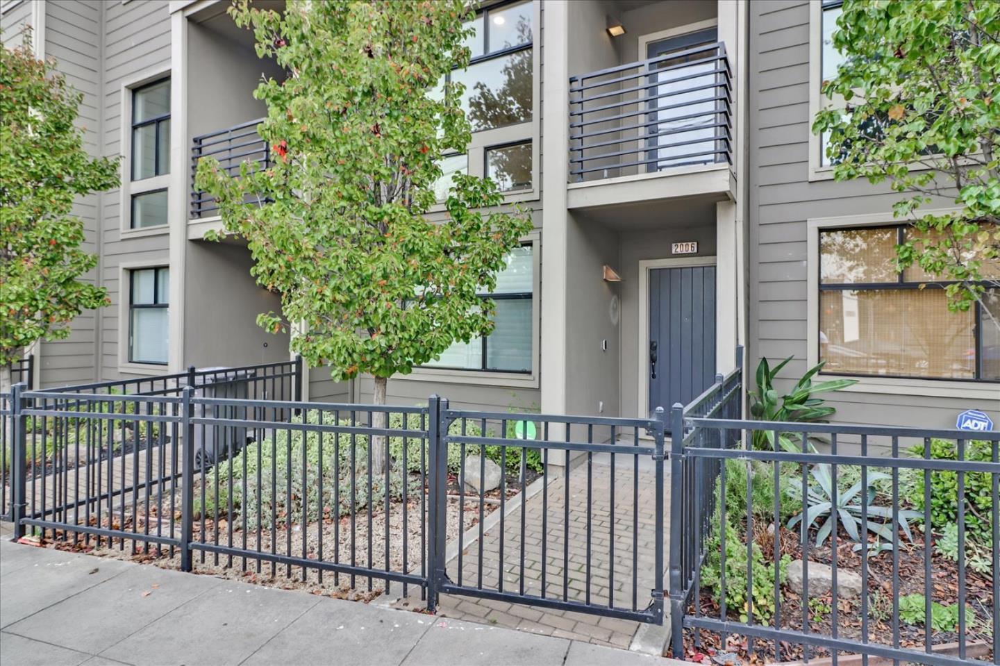 a view of a house with a small yard and plants