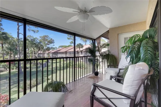 a living room with a large window and furniture