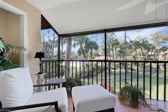 a balcony with table and chairs