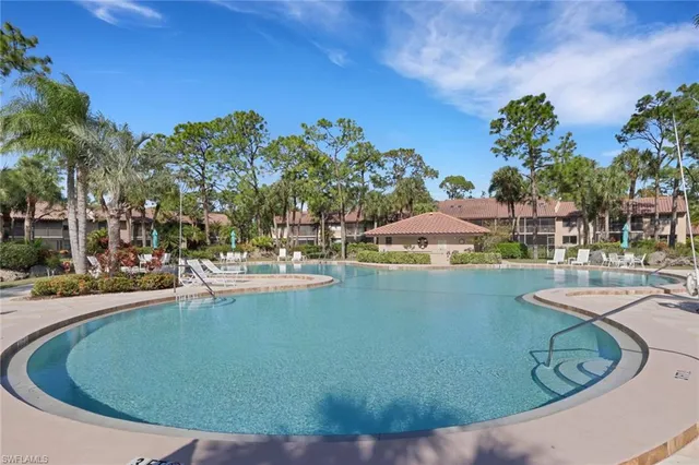 a view of a swimming pool with outdoor seating