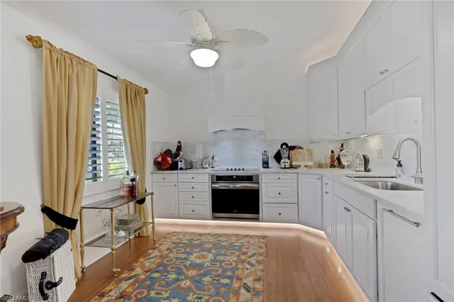 a kitchen with a stove cabinets and a sink