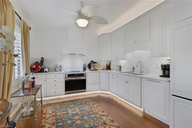 a kitchen with granite countertop cabinets and white appliances