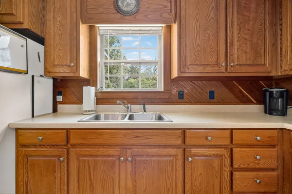 a kitchen with a sink cabinets and a window