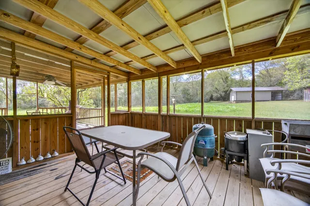 a view of a patio with chairs and couches with wooden floor