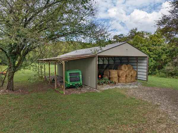 a front view of a house with yard and green space