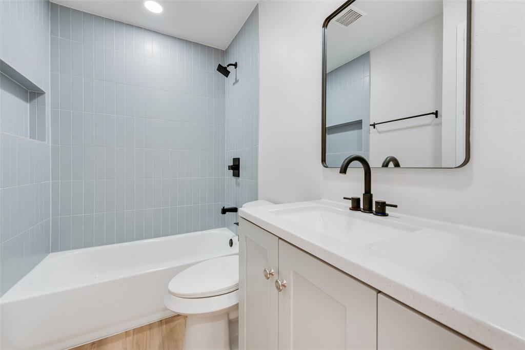 4117 Spokane Street Irving, TX 75062 - Photo 16 of 28 a bathroom with a sink and a toilet