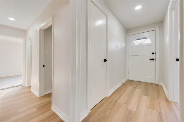 a view of a hallway with wooden floor