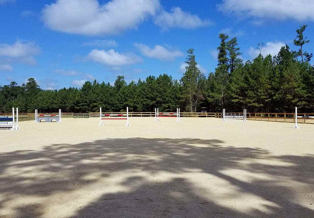 1522 Freedom Road Smithfield, NC 27577 - Photo 22 of 25 125’x240’ 3-board rough cut fencing; pro graded for proper drainage w/ non-washed screening base & 1’ sand material. Includes 10 premium hunter/jumper jumps from Old Dominion; 5x12’ viewing platform @ pond; open area near arena for round pen if desired Arena