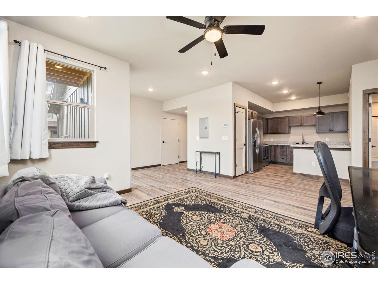 1734 Wildfire Road, Unit 102 Estes Park, CO 80517 - Photo 11 of 33 a living room with furniture and a ceiling fan