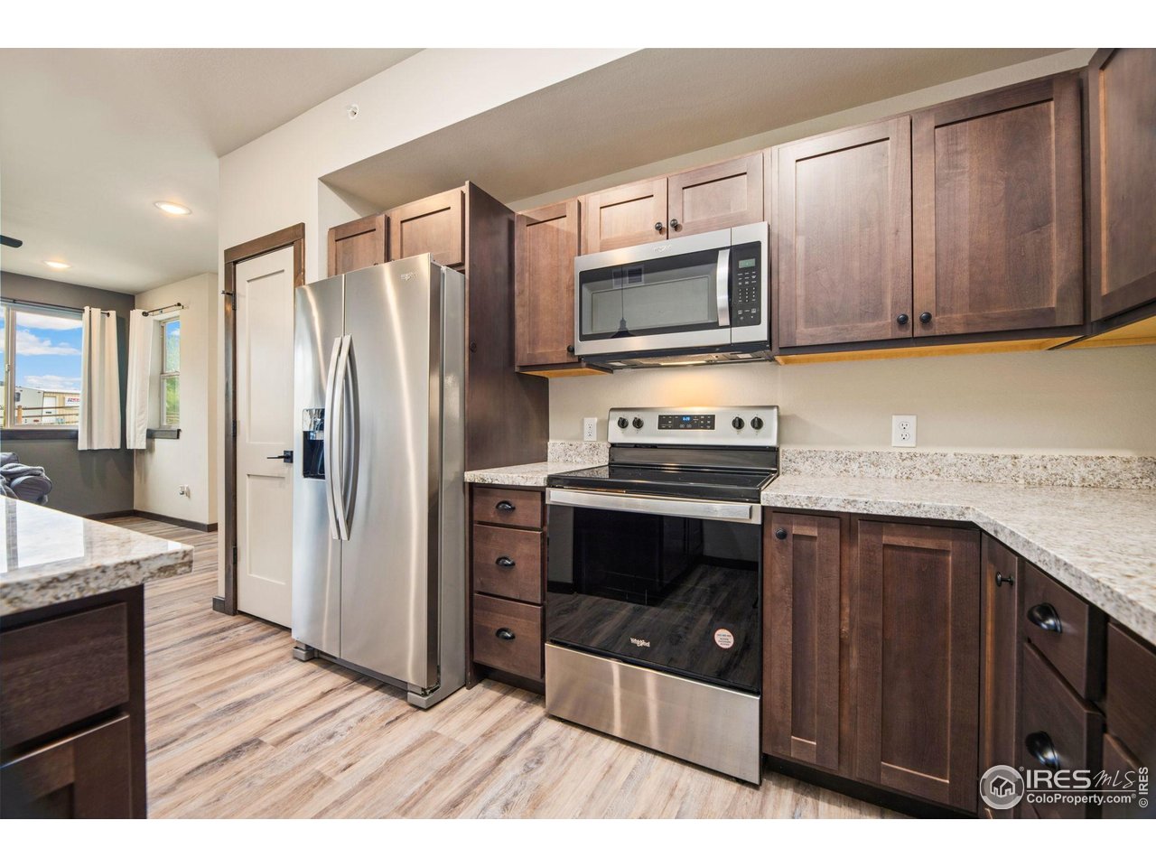 1734 Wildfire Road, Unit 102 Estes Park, CO 80517 - Photo 19 of 33 a kitchen with stainless steel appliances granite countertop a refrigerator stove and sink