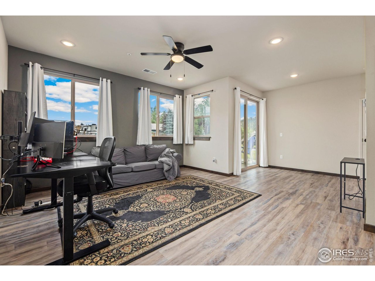 1734 Wildfire Road, Unit 102 Estes Park, CO 80517 - Photo 6 of 33 a living room with furniture and a wooden floor