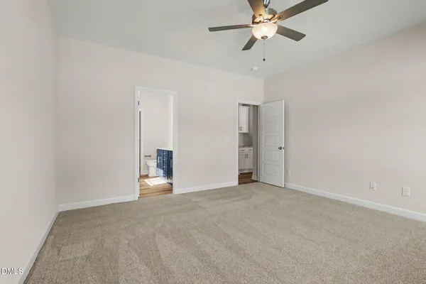 a view of a hallway with wooden floor and entryway