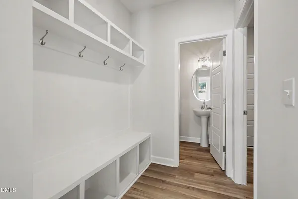 a bathroom with a bathtub sink vanity and mirror