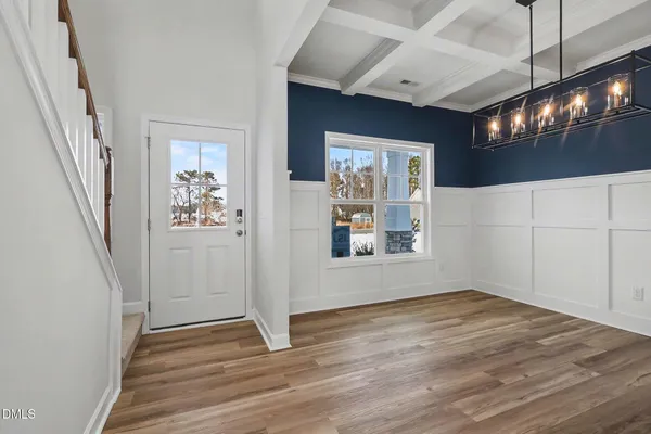 a view of a livingroom with wooden floor and stairs